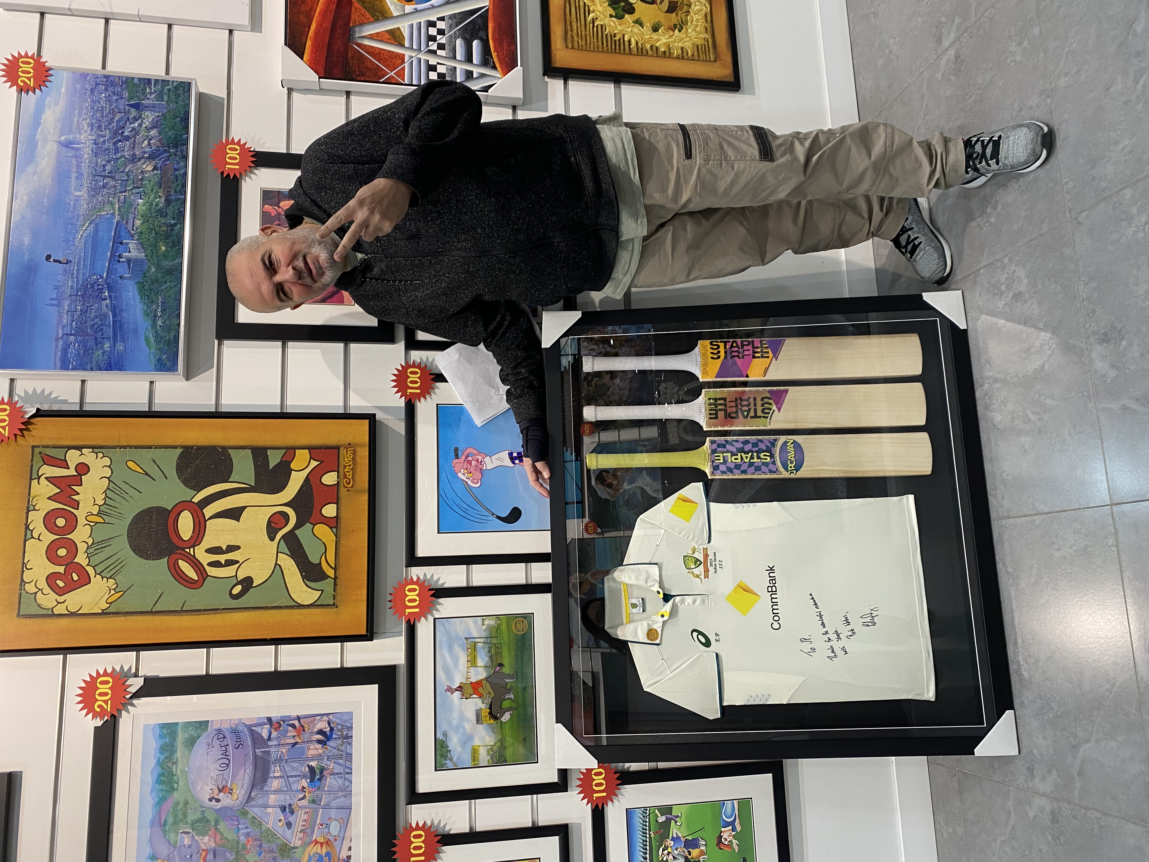 Framed cricket jersey with multiple bats in a deep display frame